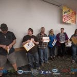 The winners opening their envelopes at once.