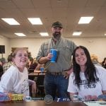 Abbie, Adam, and Amy at the welcome table.